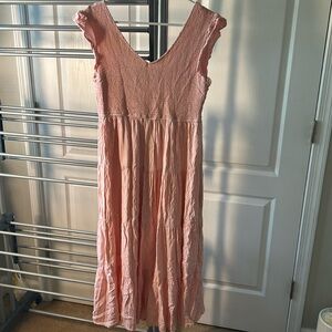 Pink long, flowy dress.